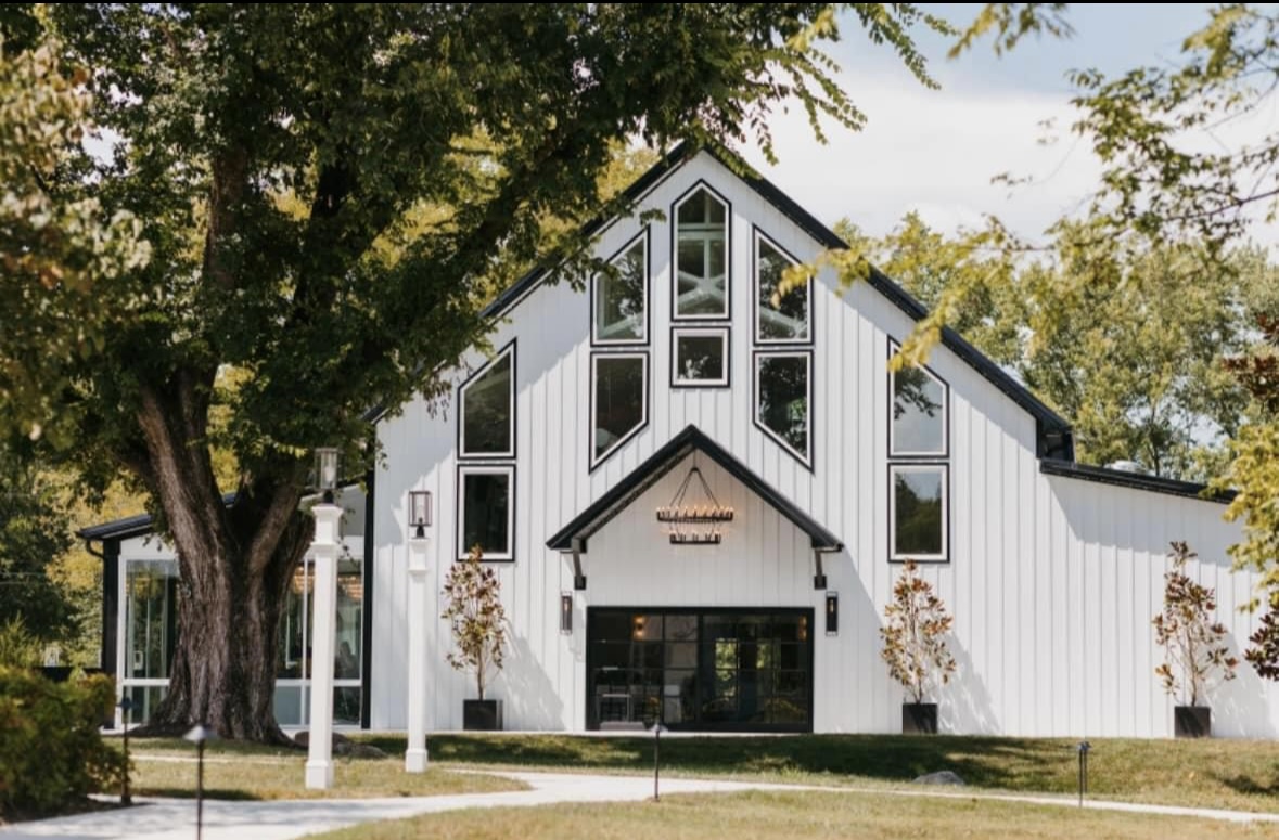 Macca Villa main building is centered and showcases the white front of the building with beautiful, large glass windows.